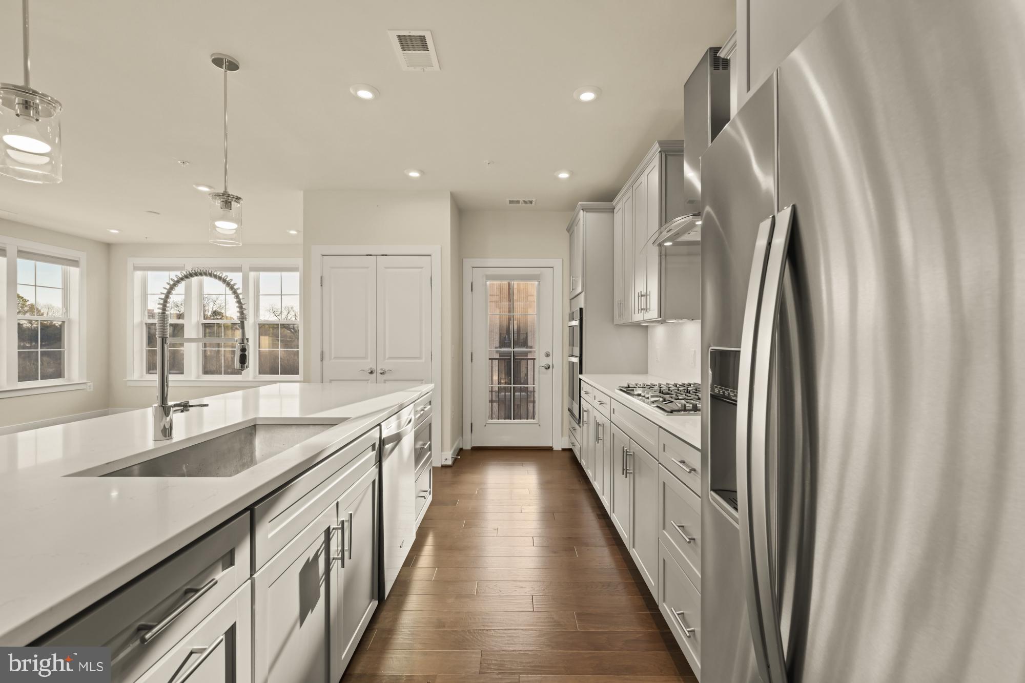 2320 Field Point Road, Unit 4304 Herndon, VA 20171 - Photo 9 of 43 a large kitchen with kitchen island granite countertop lots of counter space a sink a window and stainless steel appliances