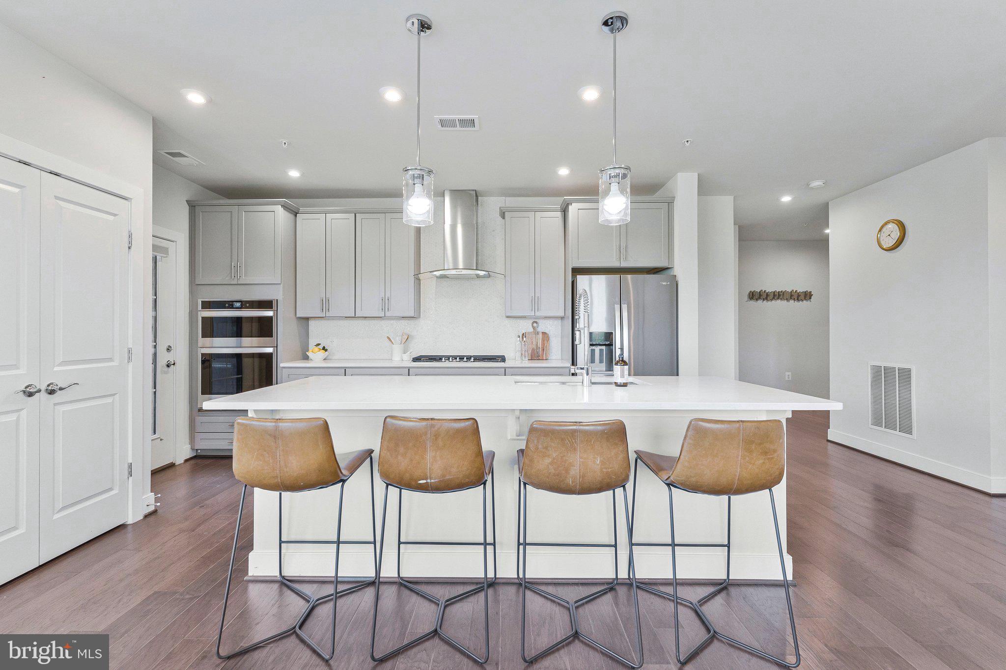 2320 Field Point Road, Unit 4304 Herndon, VA 20171 - Photo 10 of 42 a kitchen with stainless steel appliances granite countertop a kitchen island a stove a cabinets and a chairs