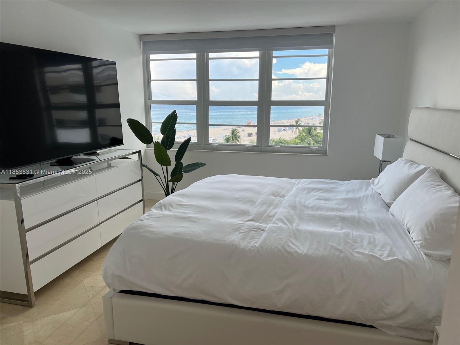 100 Lincoln Road, Unit 848 Miami Beach, FL 33139 - Photo 19 of 68 a bed sitting in a bedroom next to a window
