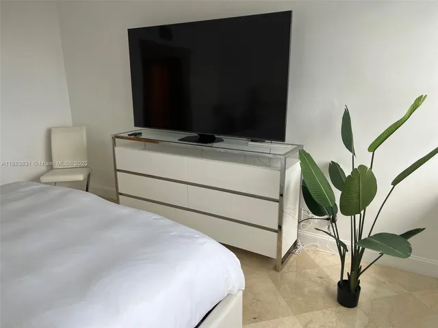 a bedroom with a bed and a mirror