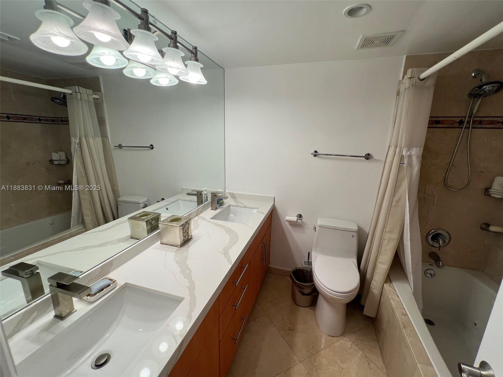 100 Lincoln Road, Unit 848 Miami Beach, FL 33139 - Photo 22 of 68 a bathroom with a sink a toilet a mirror and shower