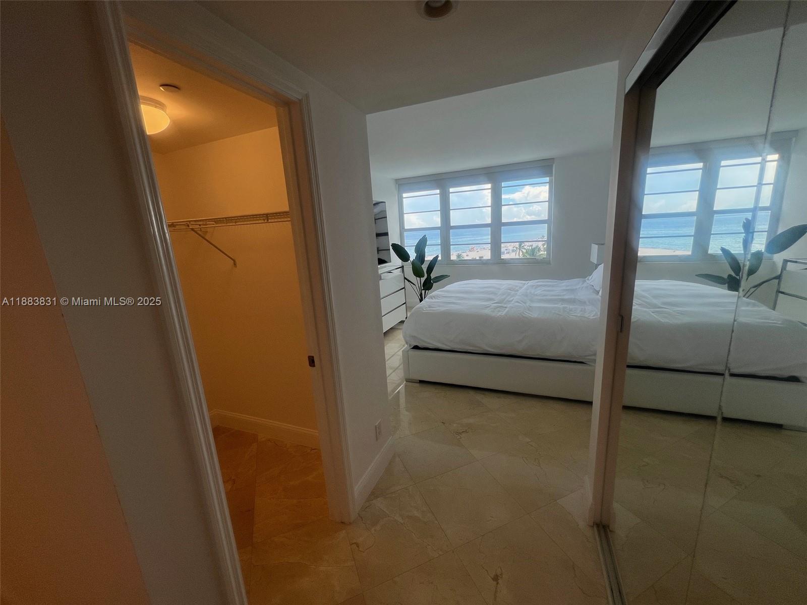 100 Lincoln Road, Unit 848 Miami Beach, FL 33139 - Photo 24 of 68 a bedroom with a bed and a mirror