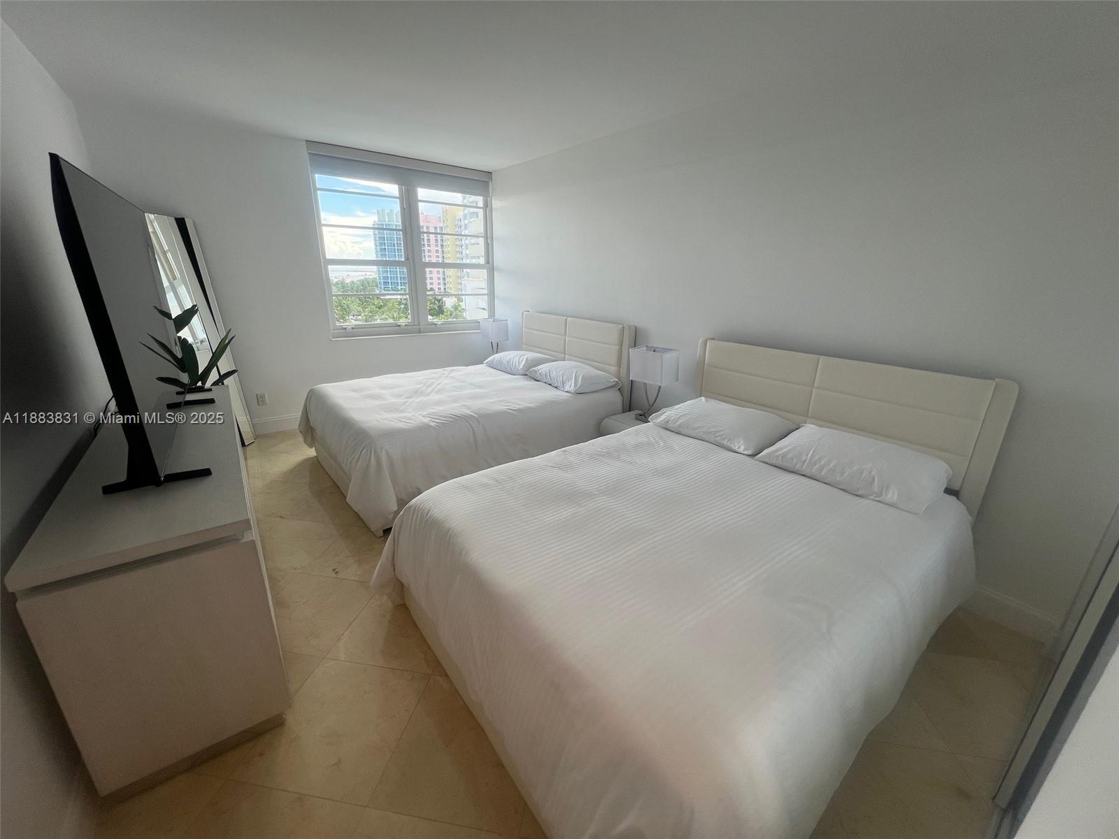 100 Lincoln Road, Unit 848 Miami Beach, FL 33139 - Photo 26 of 68 a bed sitting in a bedroom next to a window