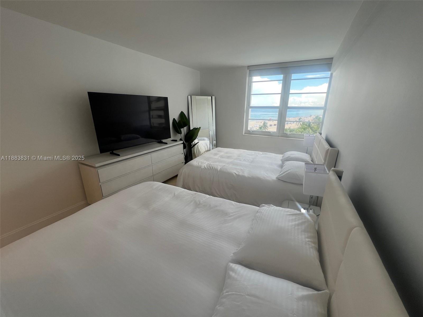 100 Lincoln Road, Unit 848 Miami Beach, FL 33139 - Photo 27 of 68 a bedroom with a bed and a flat screen tv