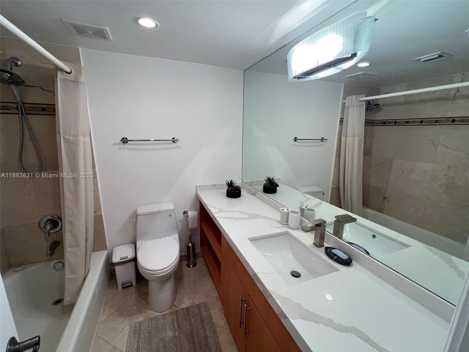 100 Lincoln Road, Unit 848 Miami Beach, FL 33139 - Photo 30 of 68 a bathroom with a sink toilet and shower