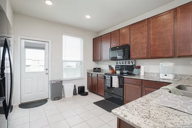 a kitchen with a sink stove and refrigerator