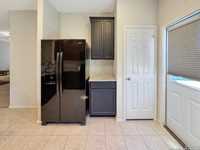 a refrigerator freezer sitting inside of a kitchen