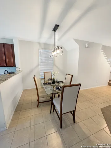 a dining room with furniture and a flat screen tv