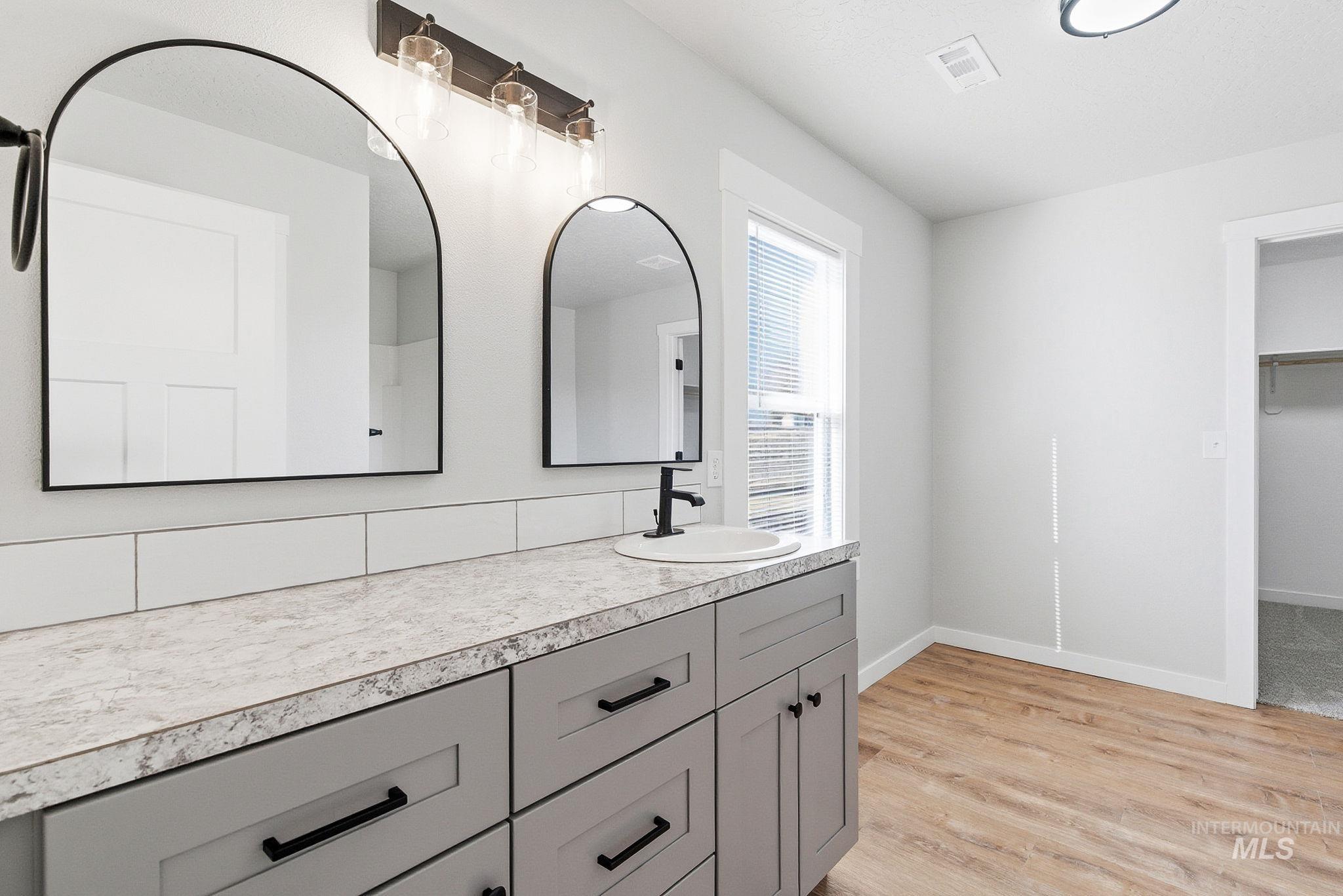 3312 Vistapark Drive Caldwell, ID 83605 - Photo 11 of 17 Full bath featuring light wood-style flooring, vanity, and a spacious closet