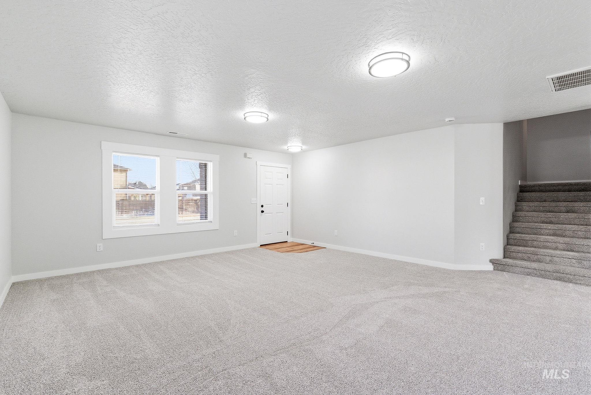 3312 Vistapark Drive Caldwell, ID 83605 - Photo 16 of 17 Spare room featuring a textured ceiling and light carpet