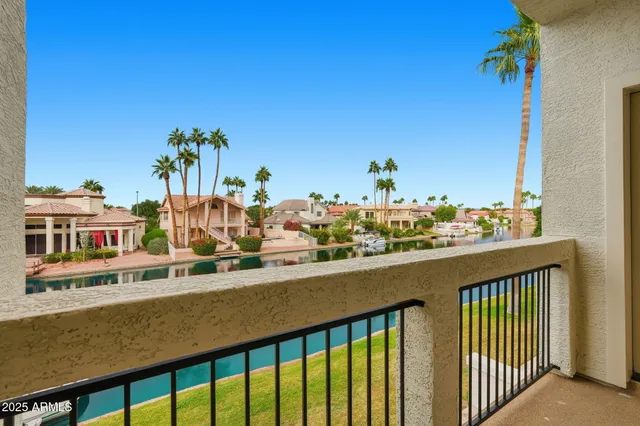 a view of swimming pool with outdoor seating and lake view