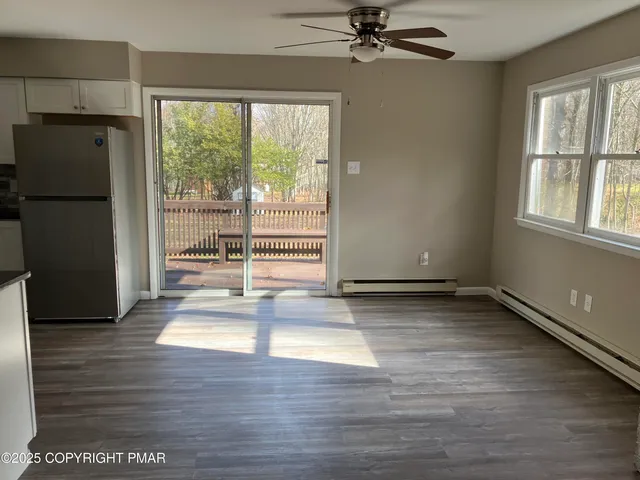 a view of a livingroom with a fireplace and a window