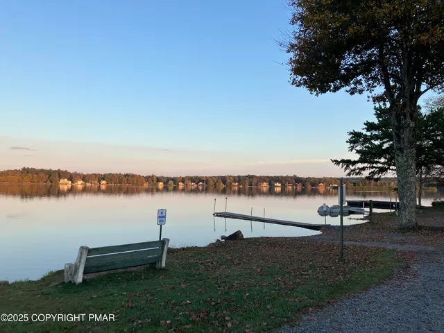 a view of house with yard and sitting area