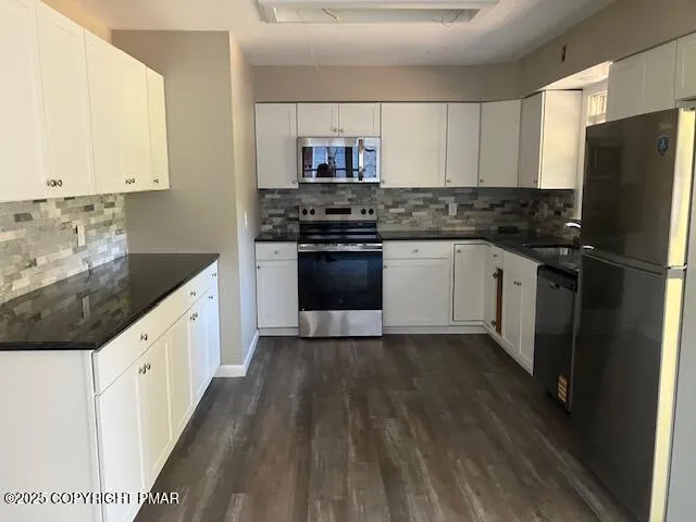 a kitchen with granite countertop a refrigerator and a stove