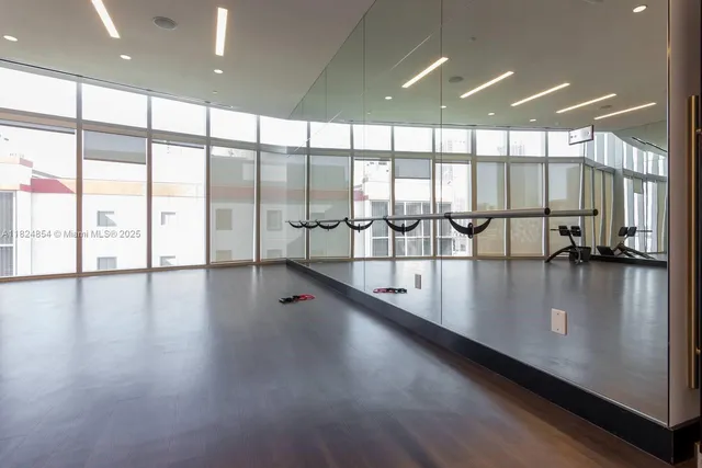 a living room with furniture a fireplace and windows