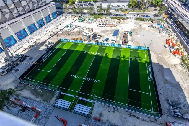a view of a building with garden and sitting area