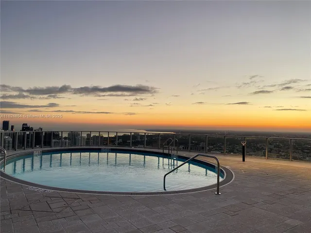 a kitchen with stainless steel appliances kitchen island granite countertop a stove a sink and a microwave