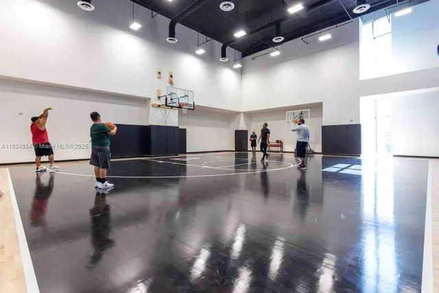 a kitchen with stainless steel appliances kitchen island a table and chairs in it