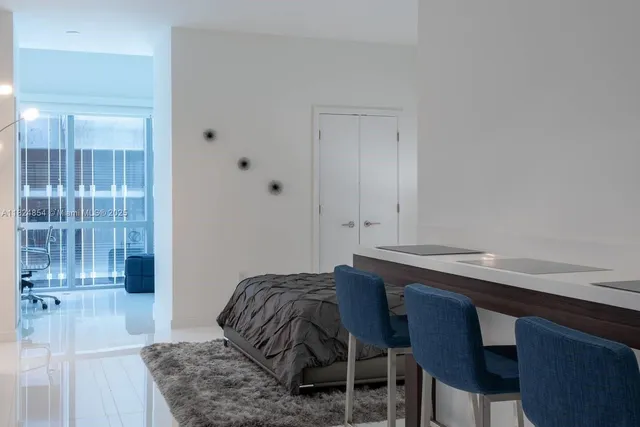 a bedroom with a bed and a table in it