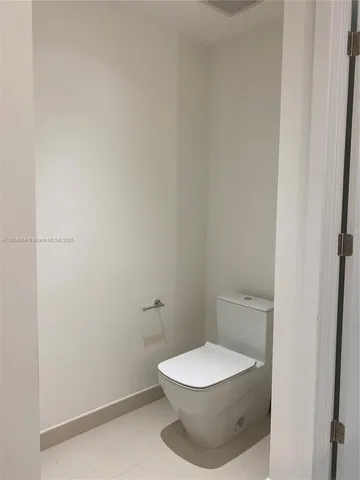 a white toilet sitting next to a white sink