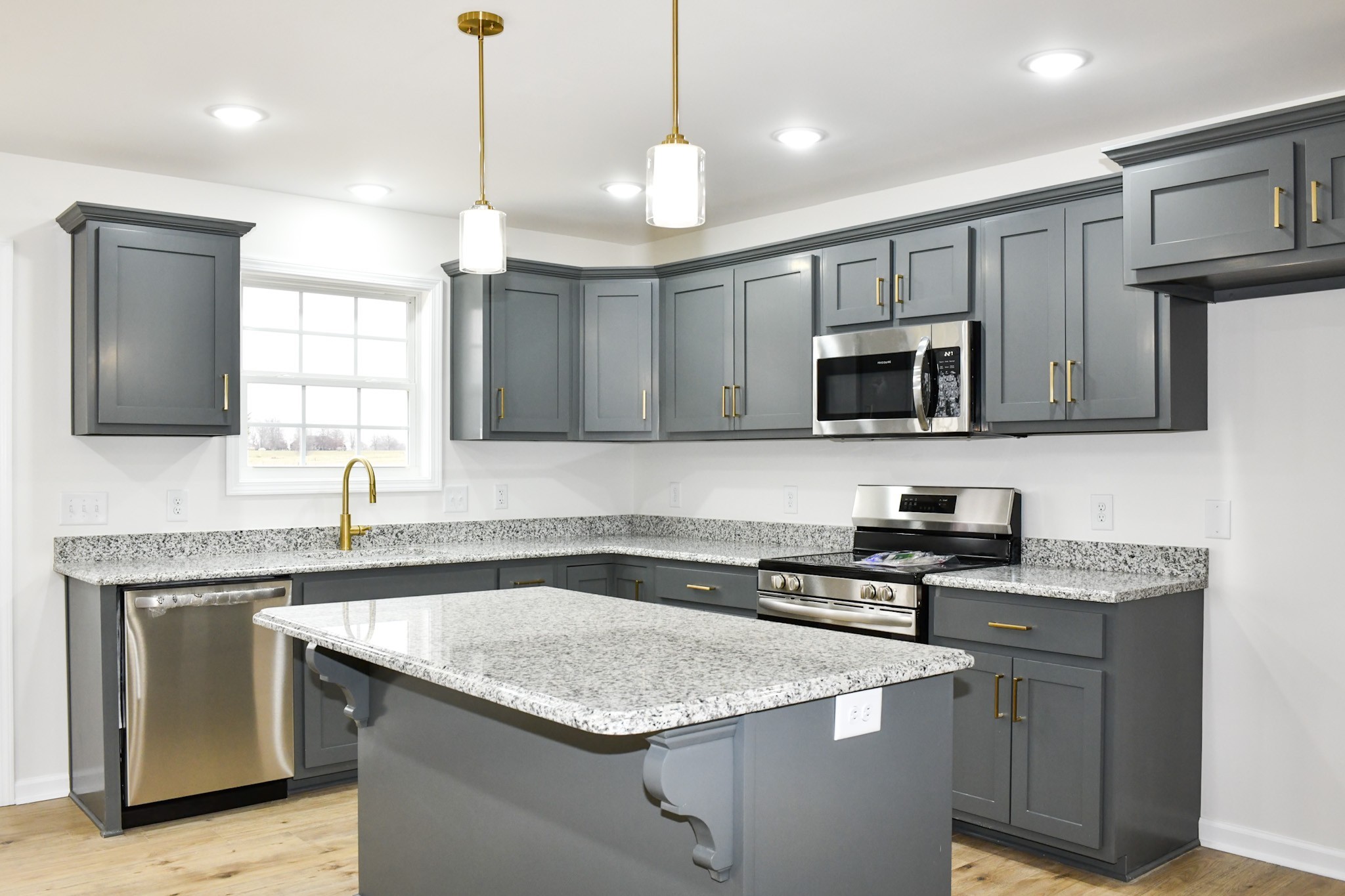 1199 Coleytown Road Lafayette, TN 37083 - Photo 8 of 23 a kitchen with stainless steel appliances granite countertop a sink stove a microwave and wooden cabinets