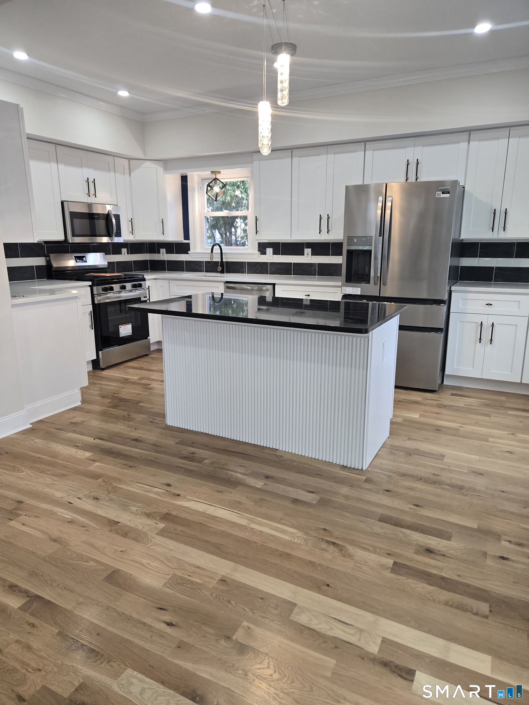 8 Pine Street Norwich, CT 06360 - Photo 12 of 27 a kitchen with stainless steel appliances granite countertop a refrigerator sink and cabinets