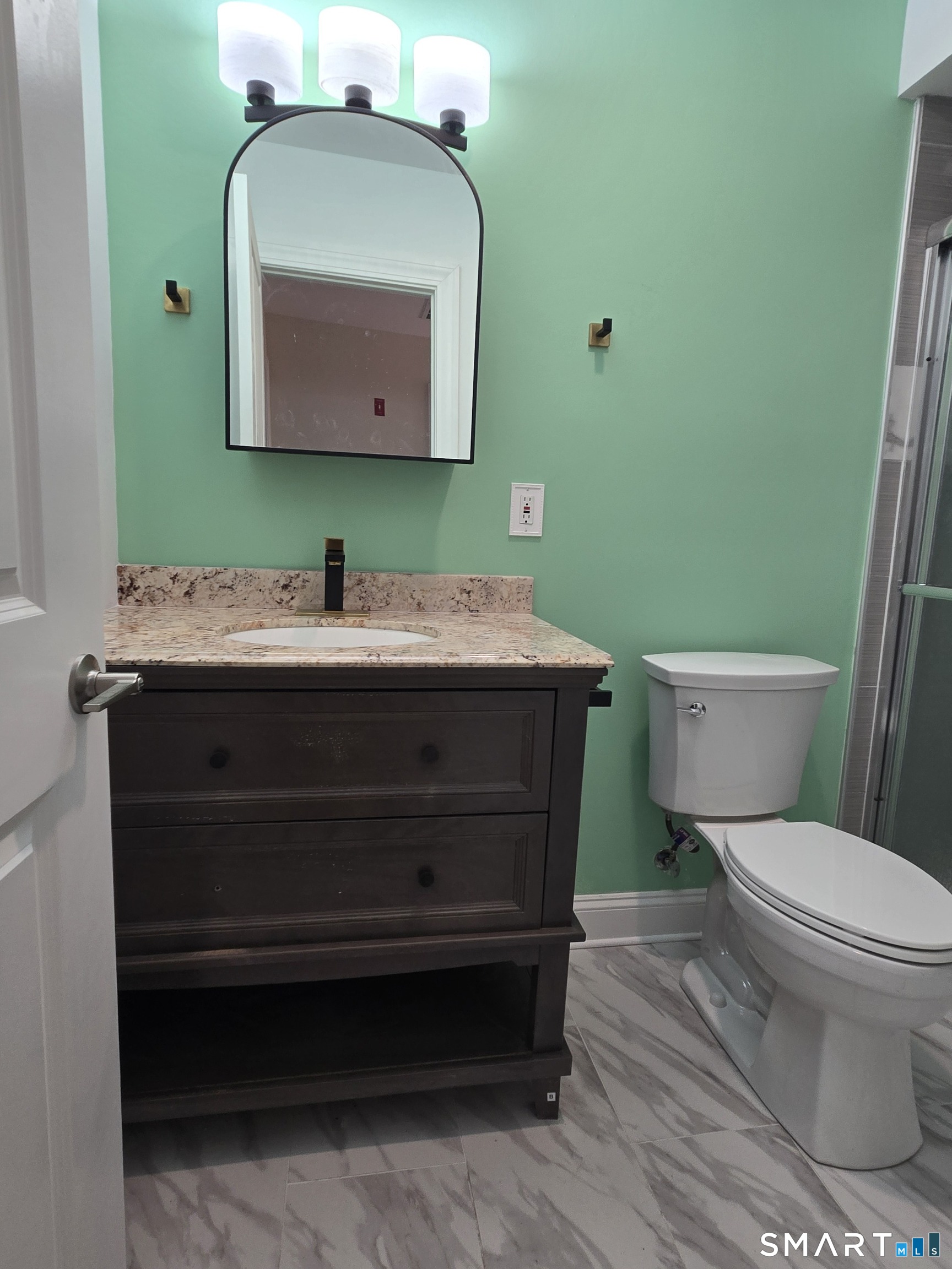 8 Pine Street Norwich, CT 06360 - Photo 18 of 27 a bathroom with a toilet sink and mirror