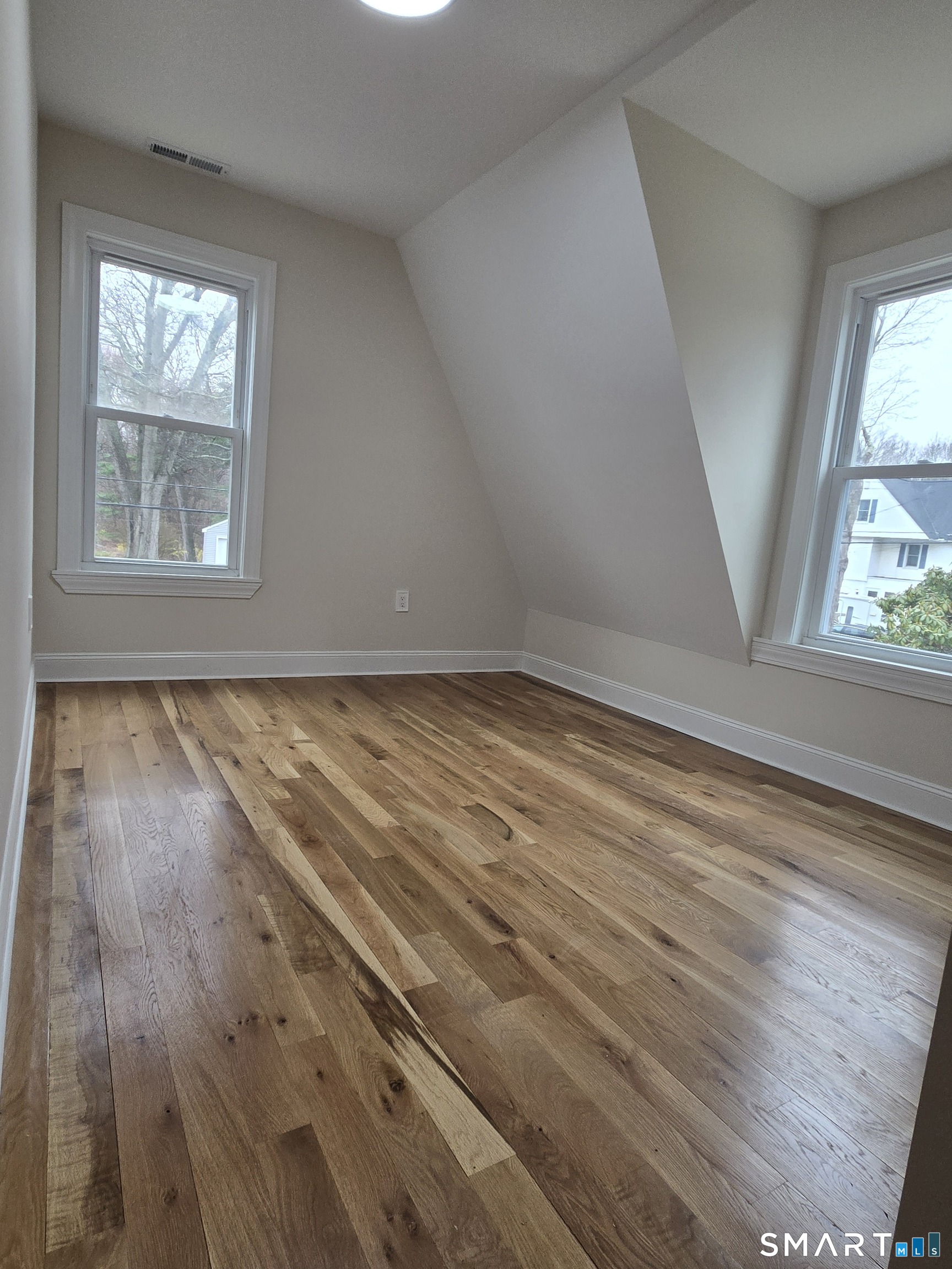 8 Pine Street Norwich, CT 06360 - Photo 22 of 27 an empty room with wooden floor and windows