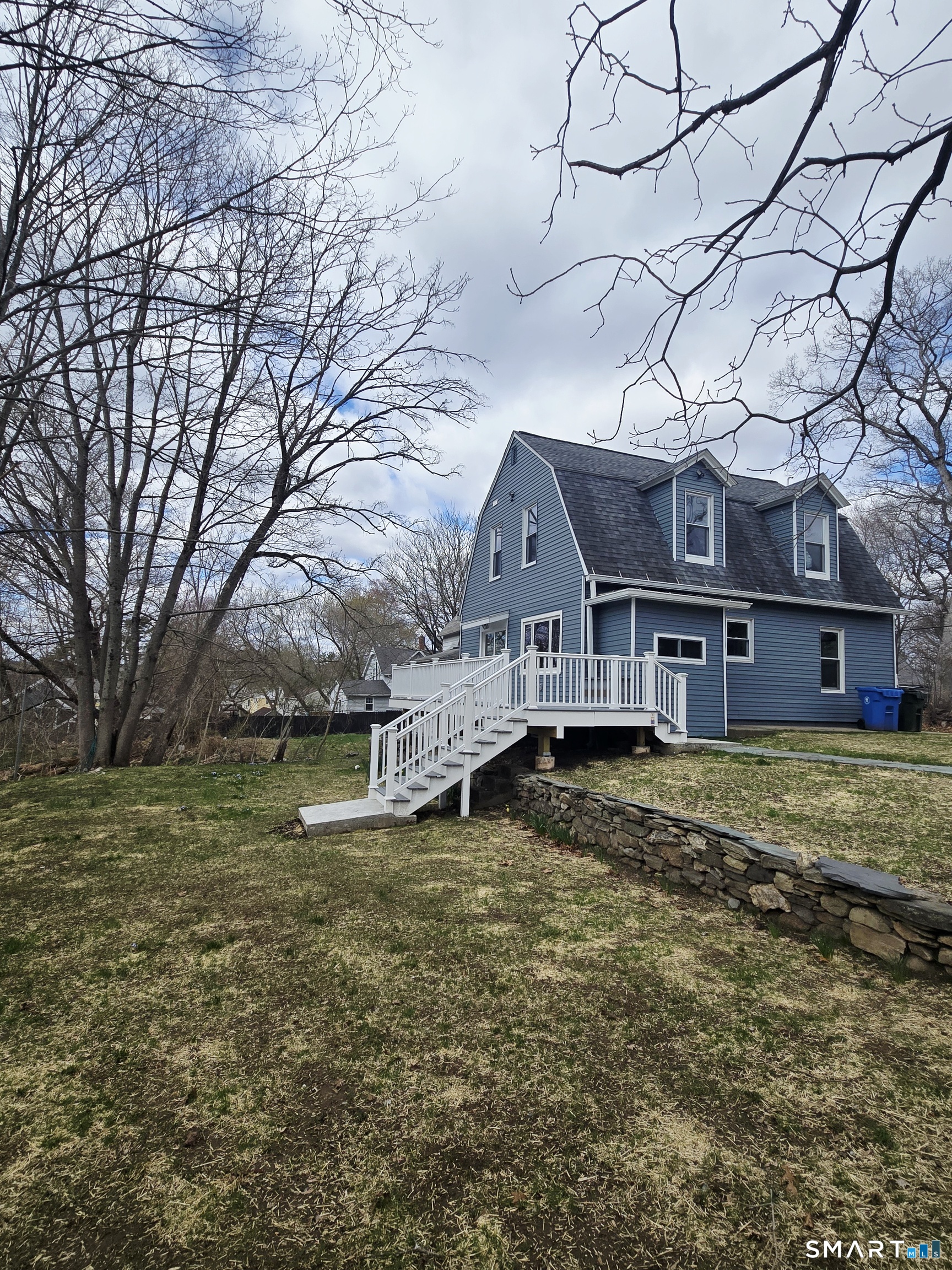 8 Pine Street Norwich, CT 06360 - Photo 10 of 27 a view of a large house with a big yard and large tree