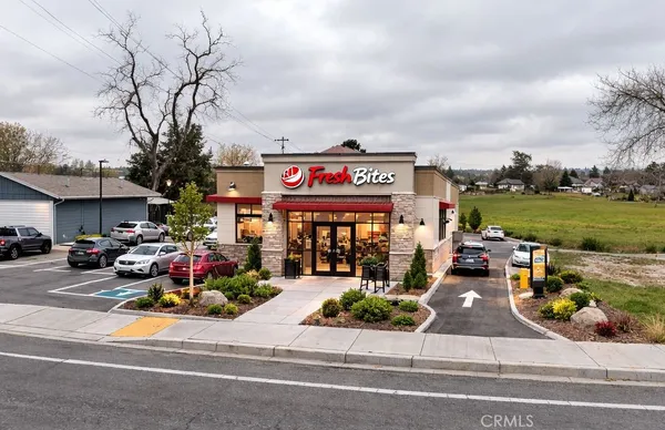 a view of a street with cars parked