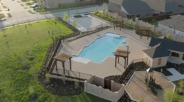 a front view of a house with a garden and yard