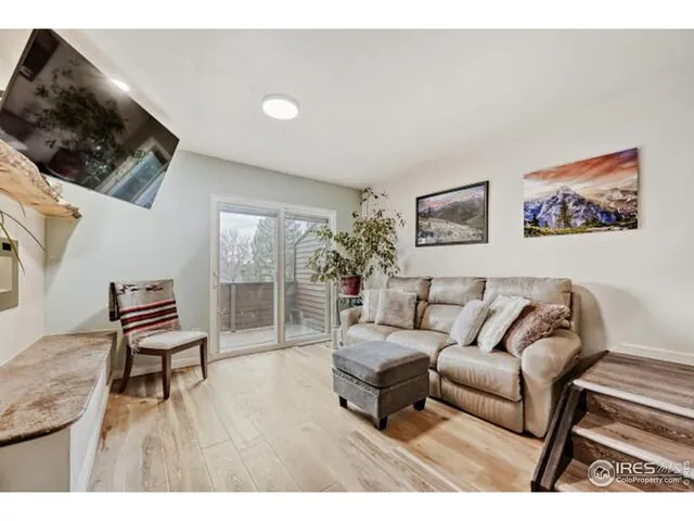 a living room with furniture and a painting on the wall