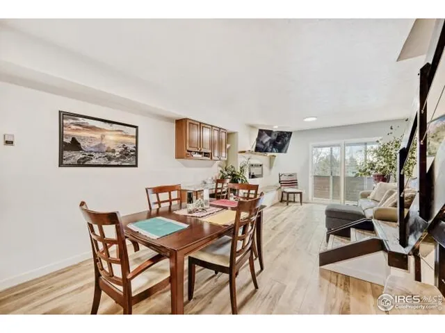 a view of a dining room with furniture wooden floor and a large window
