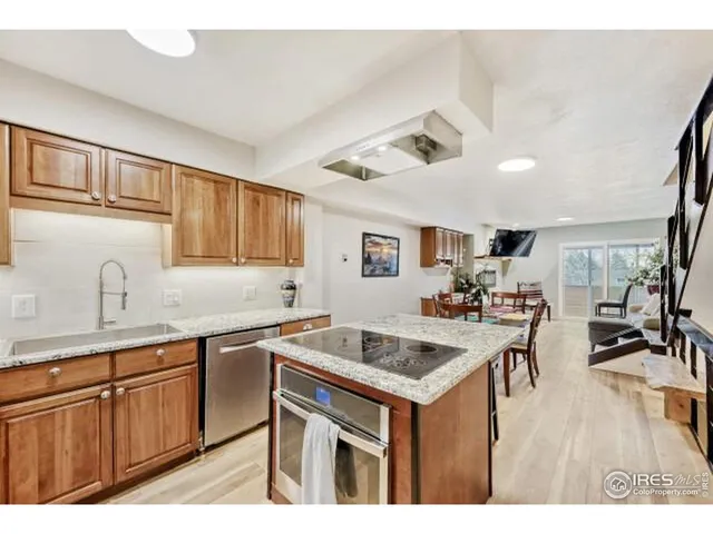 a living room with furniture a flat screen tv and a floor to ceiling window