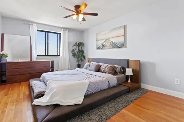 a bedroom with a bed and a painting on the wall