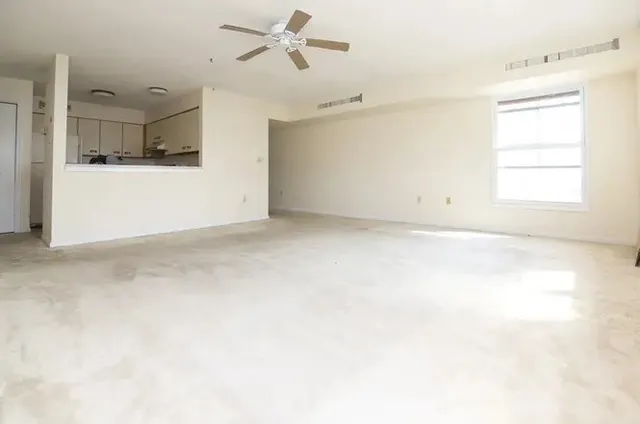 a view of a kitchen with a sink and cabinets