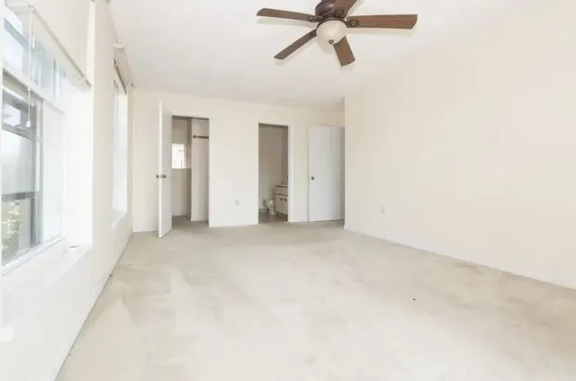 a view of a room with a ceiling fan