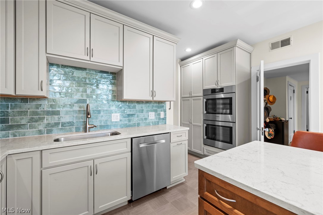 12546 Cedar Road, Unit 4 Cleveland Heights, OH 44106 - Photo 20 of 43 Newer windows, gourmet Kitchen taken down to the studs with center island and breakfast bar, 2 sinks, quartz counters, all Bosch stainless appliances with induction range and 2 ovens for large gatherings
