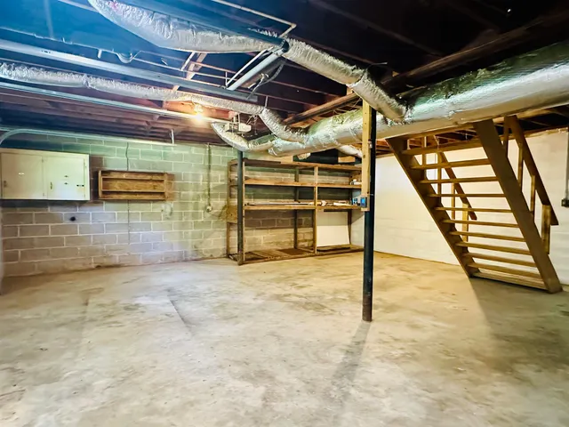 a view of empty room with wooden walls