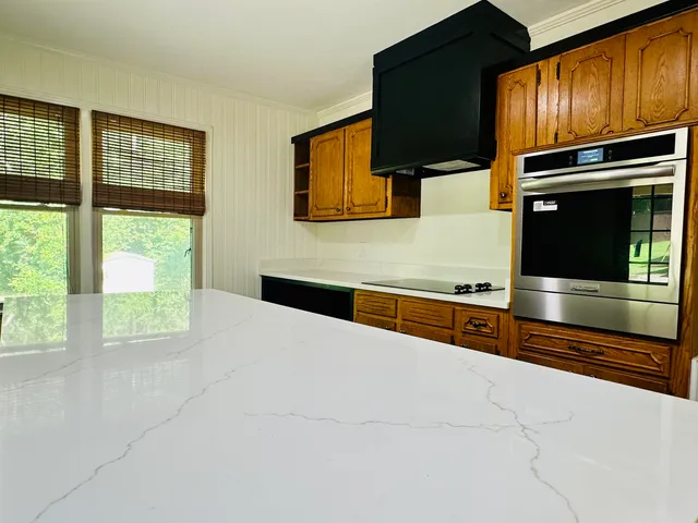 a kitchen with stainless steel appliances a stove and cabinets