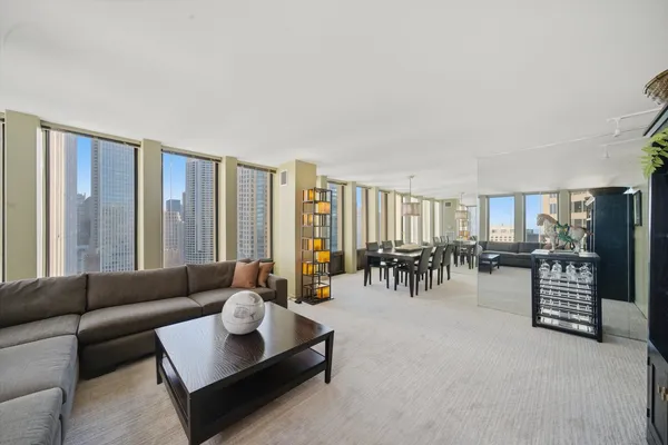 a living room with furniture and large windows