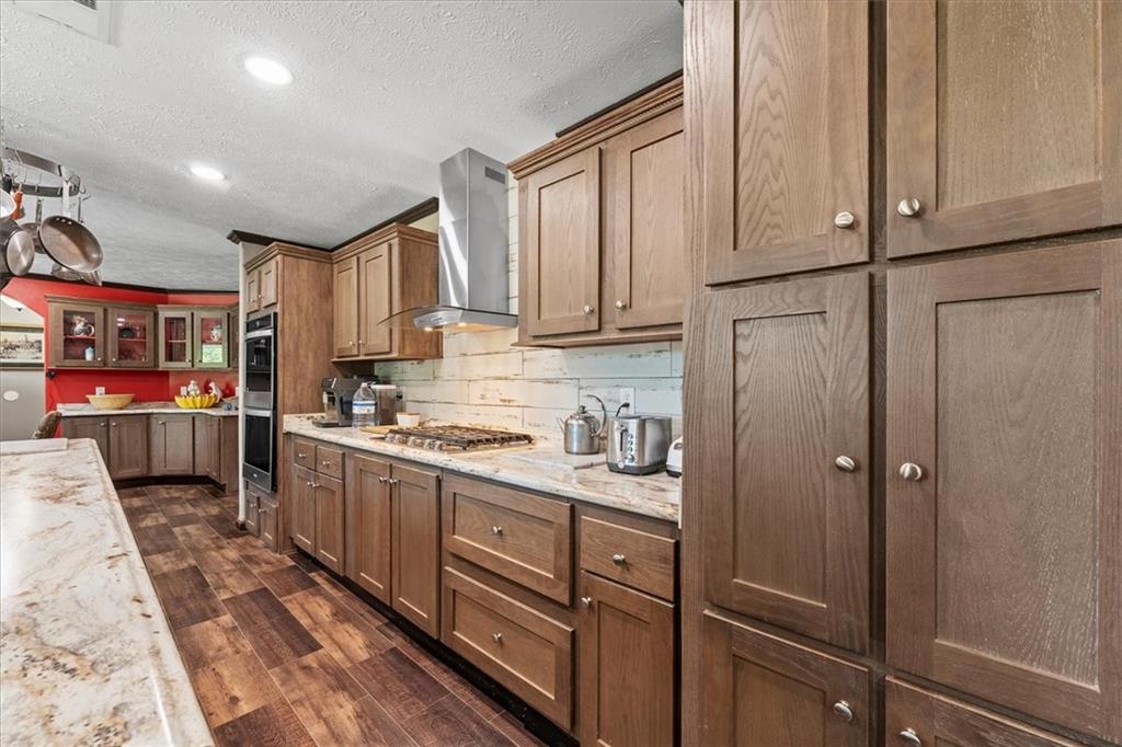 170 Anoia Road Washington, GA 30673 - Photo 10 of 46 a kitchen with stainless steel appliances granite countertop a refrigerator sink and cabinets