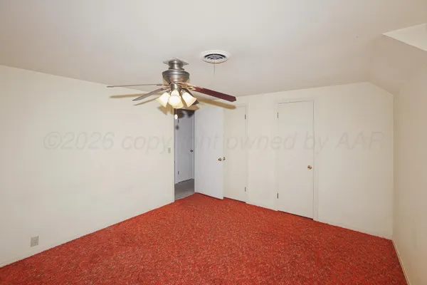 a view of a big room with a chandelier fan