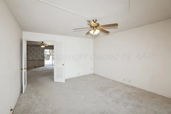 an empty room with a empty space and a ceiling fan