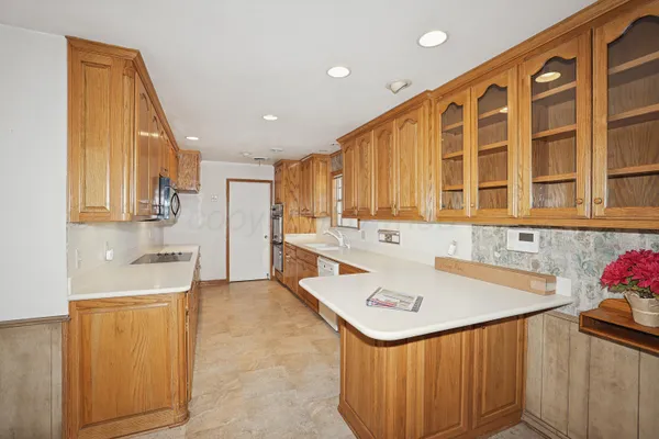 a kitchen with stainless steel appliances granite countertop a sink and cabinets