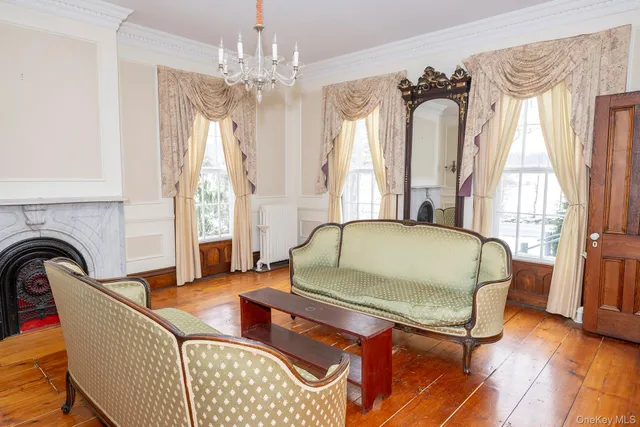 a living room with furniture and a chandelier