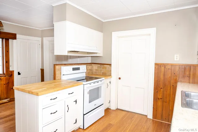 a kitchen with a stove a sink and a refrigerator