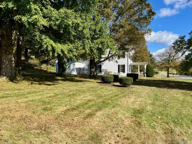 a house view with swimming pool in front of it