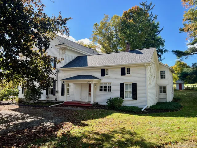 a view of a white house with a yard