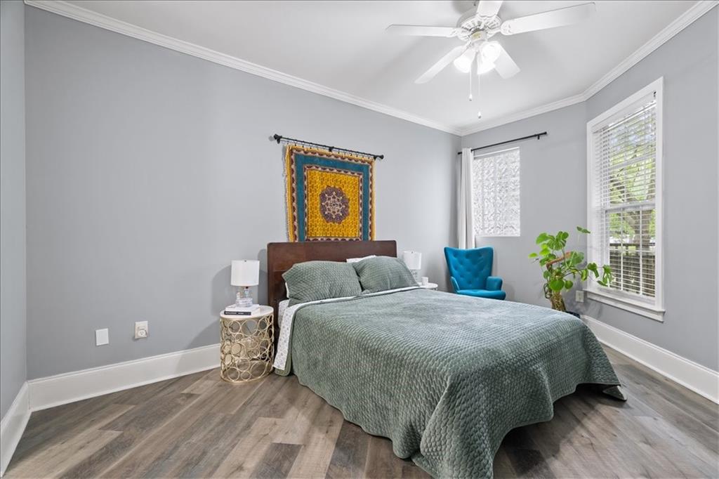 4100 Paces Walk Southeast, Unit 1101 Atlanta, GA 30339 - Photo 14 of 36 a bedroom with a bed and painting on the wall